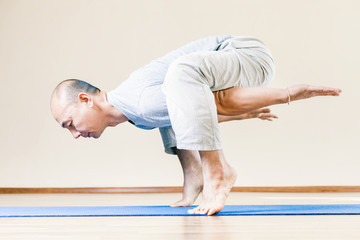 Naklejka premium Inspired asian man doing exercise of yoga indoor