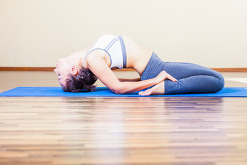 woman doing exercise of yoga indoor