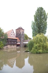 Fototapeta na wymiar Half-timbered house and medieval tower in the Old Town of Nuremb