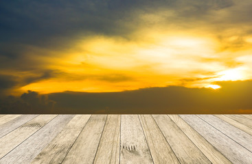 Fototapeta na wymiar perspective wood plank floor or walk way on over blur sea above sunset background