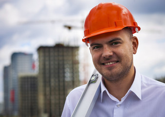 Happy worker architect showing success thumb up on the background of construction  