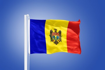 Flag of Moldova flying against a blue sky