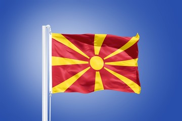 Flag of Macedonia flying against a blue sky