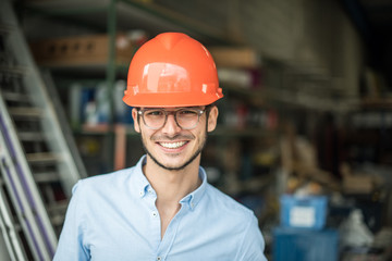  a young man with a helmet on his head on an industrial site