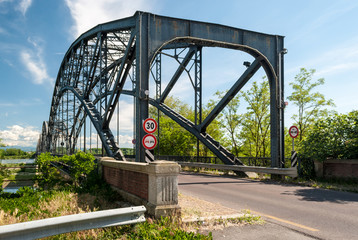 The entrance of a metal bridge across the river Po near Pavia