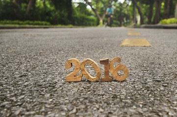 Head to New Year 2016 on road concept, wood number idea