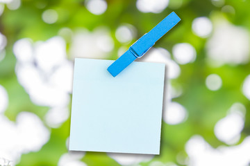 Paper color and wood clip note on Green bokeh