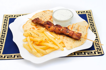 Souvlaki or kebab, grilled meat on pita bread with sauce and