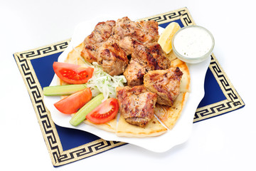 Souvlaki, kebab, grilled meat on pita bread with sauce, tomatoes