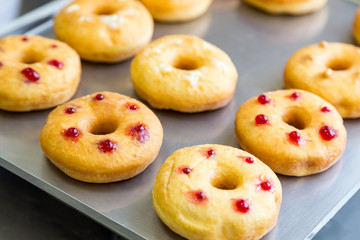 doughnuts with assorted filling on metal tray