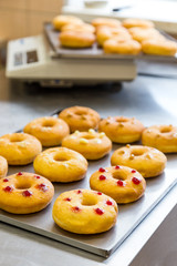 doughnuts with assorted filling on metal tray