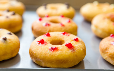 doughnuts with assorted filling on metal tray