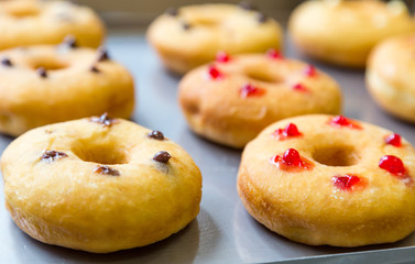 doughnuts with assorted filling on metal tray