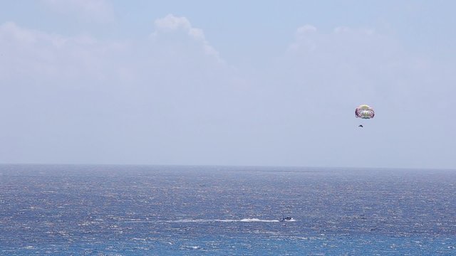 Parasailing From Boat in caribbean sea at Cancun
