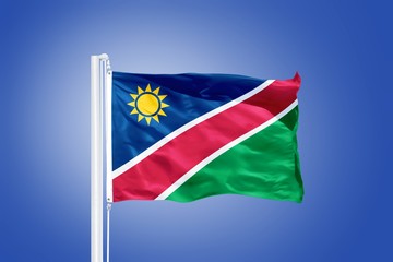 Flag of Namibia flying against a blue sky