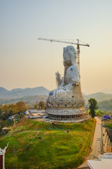 Fototapeta na wymiar Guan Yin statue under construction, Wat huay pla kang