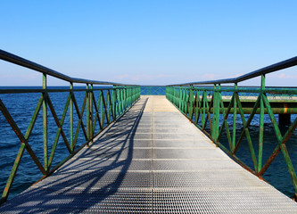 Pier at the sea with green railing © dalaxey