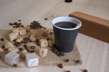 cup of fresh coffee with chocolates and sugar