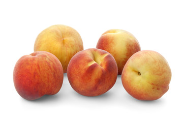 Five ripe peaches on a white background