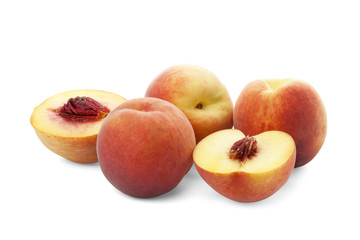 Fototapeta na wymiar three whole ripe peach and peach halves