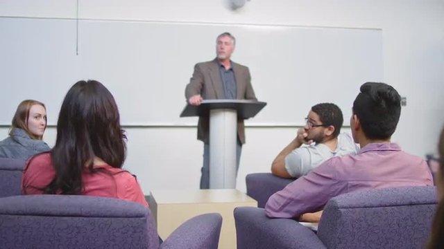 A professor calls on a student and she asks a question - Powered by Adobe