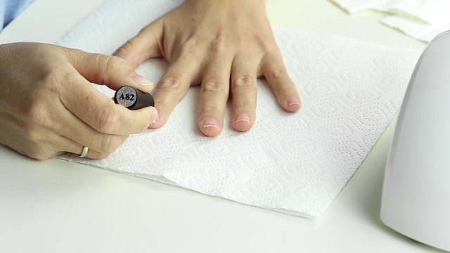 Manicure in process - painting gel polish of pink color on female nails