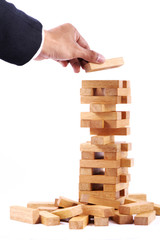 Businessman playing with the wood game (jenga).