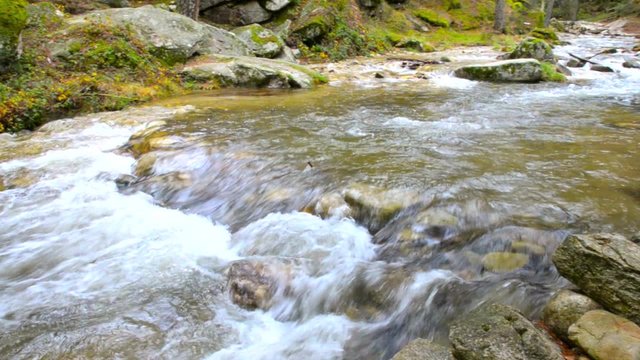 Water flowing in river Eresma at Boca del Asno natural park in Segovia, Spain. 