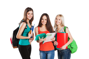 Three smiling students friends with copybooks posing isolated on