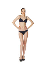 Full length portrait of a beautiful young model in black bikini