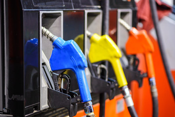 Gas pump nozzles in a service station