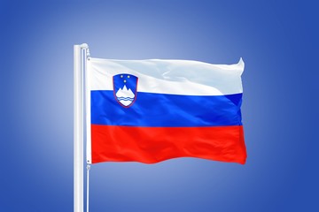 Naklejka premium Flag of Slovenia flying against a blue sky