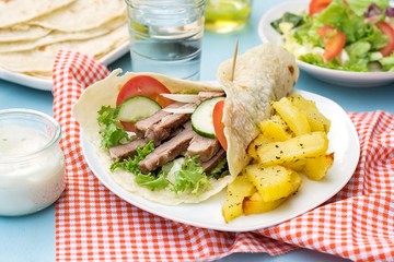 Greek gyros with pork, vegetables and homemade pita bread