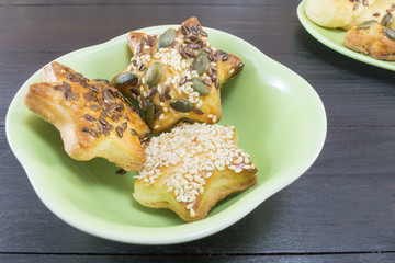 Star shaped pastry with seeds in a green plate