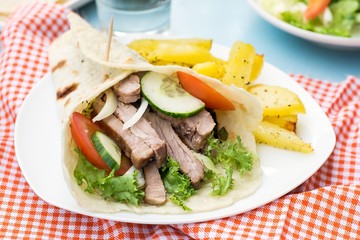 Greek gyros with pork, vegetables and homemade pita bread