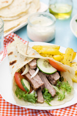 Greek gyros with pork, vegetables and homemade pita bread