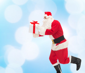 man in costume of santa claus with gift box