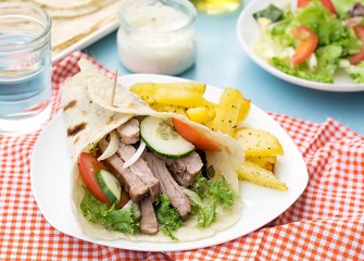 Greek gyros with pork, vegetables and homemade pita bread