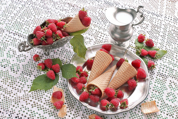 Raspberries in waffle cones  on metal plate