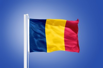 Flag of Chad flying against a blue sky