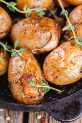 Young potatoes fried in a pan. With garlic, pancetta and thyme.selective focus