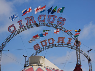 National flags flying on top of a circus marquee