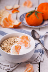 Oatmeal with homemade yogurt and tangerines,muesli.