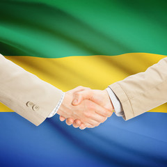 Businessmen handshake with flag on background - Gabon