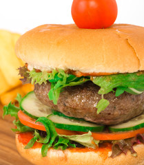 Beef burger on the wooden plate with fried potato