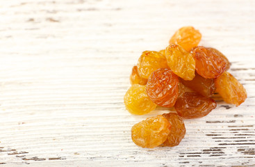 Heap of raisins on wooden background
