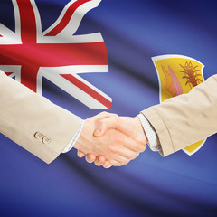 Businessmen handshake with flag on background - Turks and Caicos