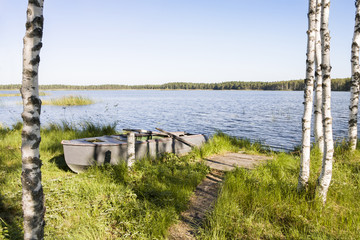 Old oar boat at lake coast