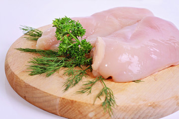 Raw chicken breast fillets  on wooden cutting board