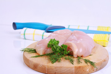 Raw chicken breast fillets  on wooden cutting board